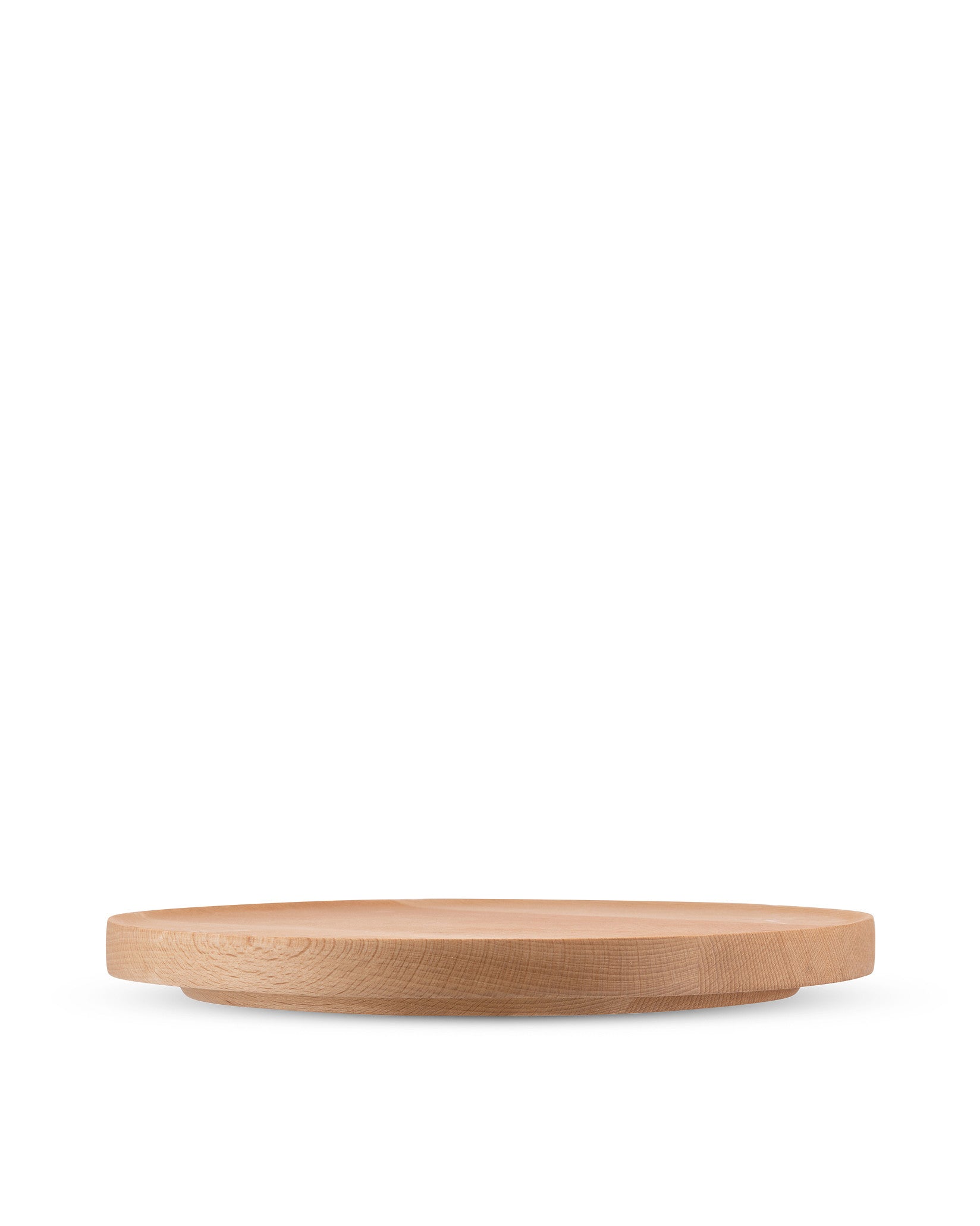 Round light wood board by Alessi with subtle elevation and visible wood grain.