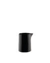 A small black pitcher by Alessi with a minimalist, cylindrical design and a glossy finish.