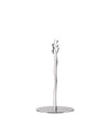 Silver sculptural metal stand by Alessi with an organic branch-like top and flat round base.