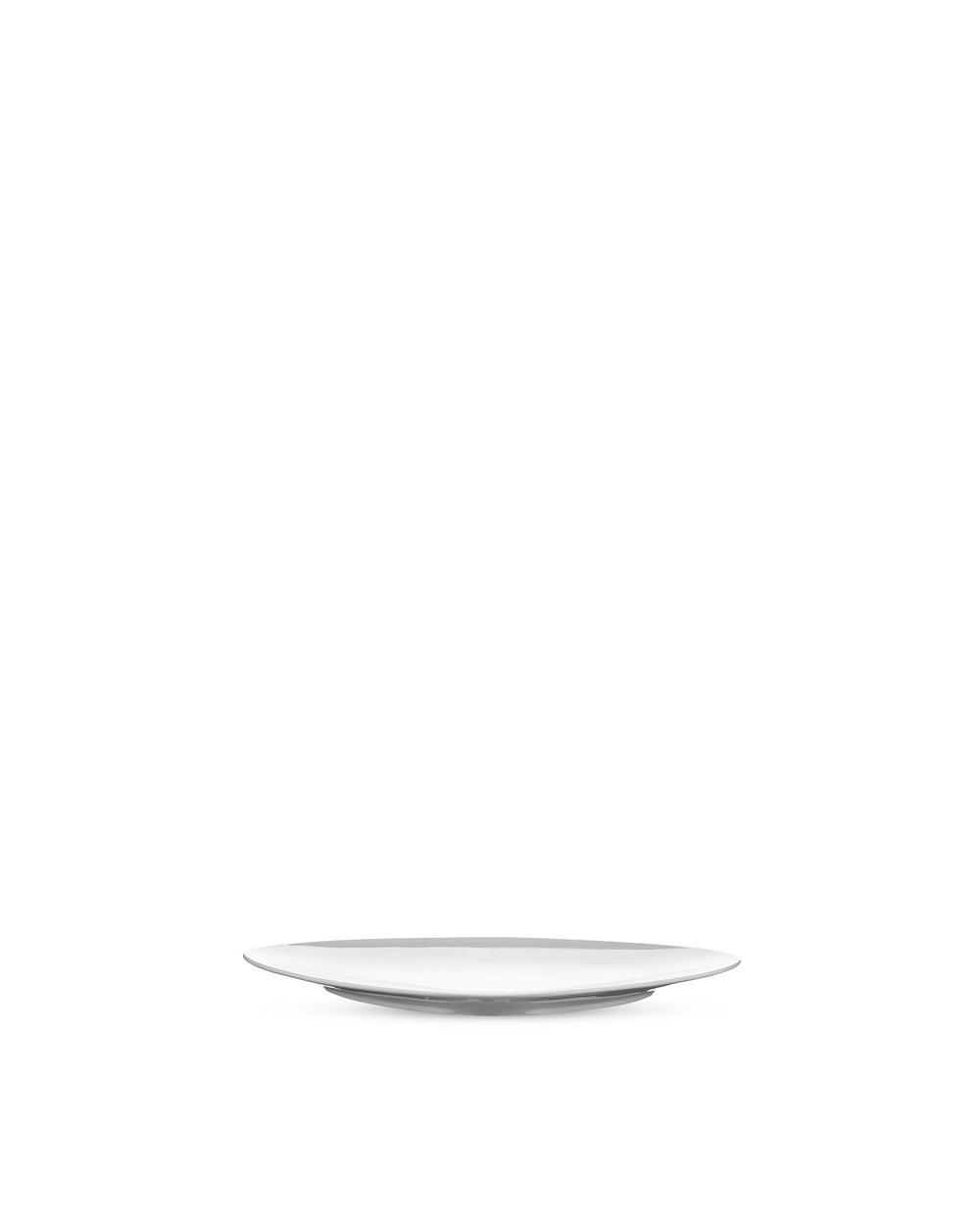 White modern plate by Alessi, minimalist design, viewed from a low angle.