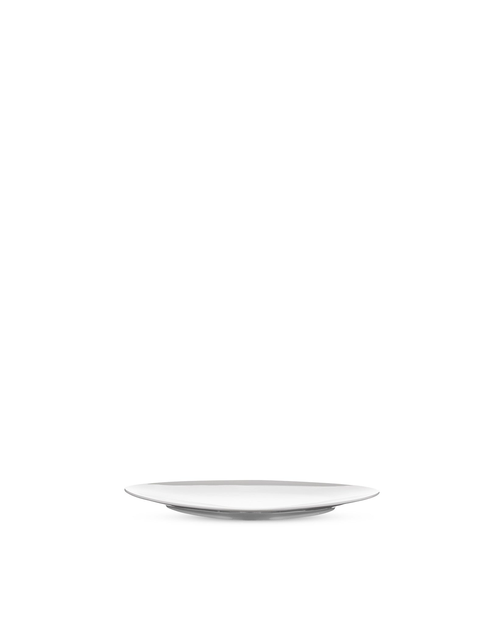 White modern plate by Alessi, minimalist design, viewed from a low angle.
