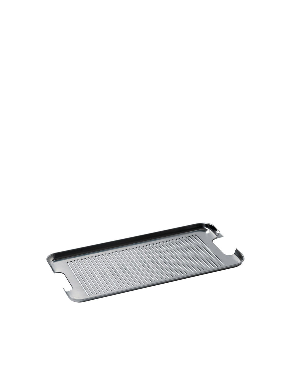 Silver stainless steel grill tray by Alessi with parallel ridges and integrated cut-out handles, angled view.