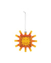 A translucent orange and yellow sunflake ornament by Alessi, with a smiling square face and radiating blocky rays, hanging from a silver chain.