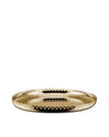Golden oval serving tray by Alessi with a perforated edge of small circles and a reflective surface.