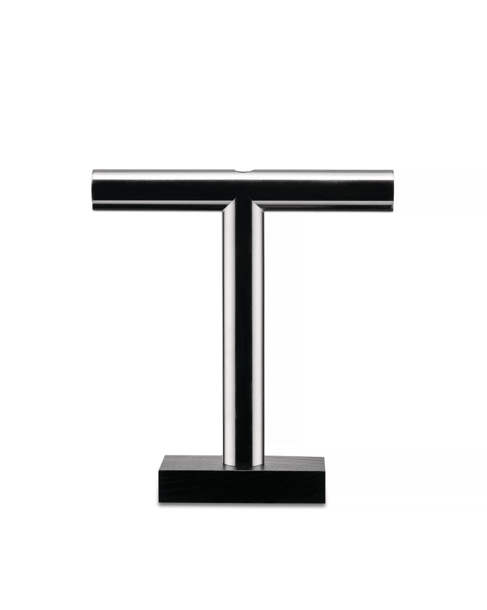 Silver metallic T-shaped Tronchetto vase by Alessi with a rectangular black wooden base on a white background.