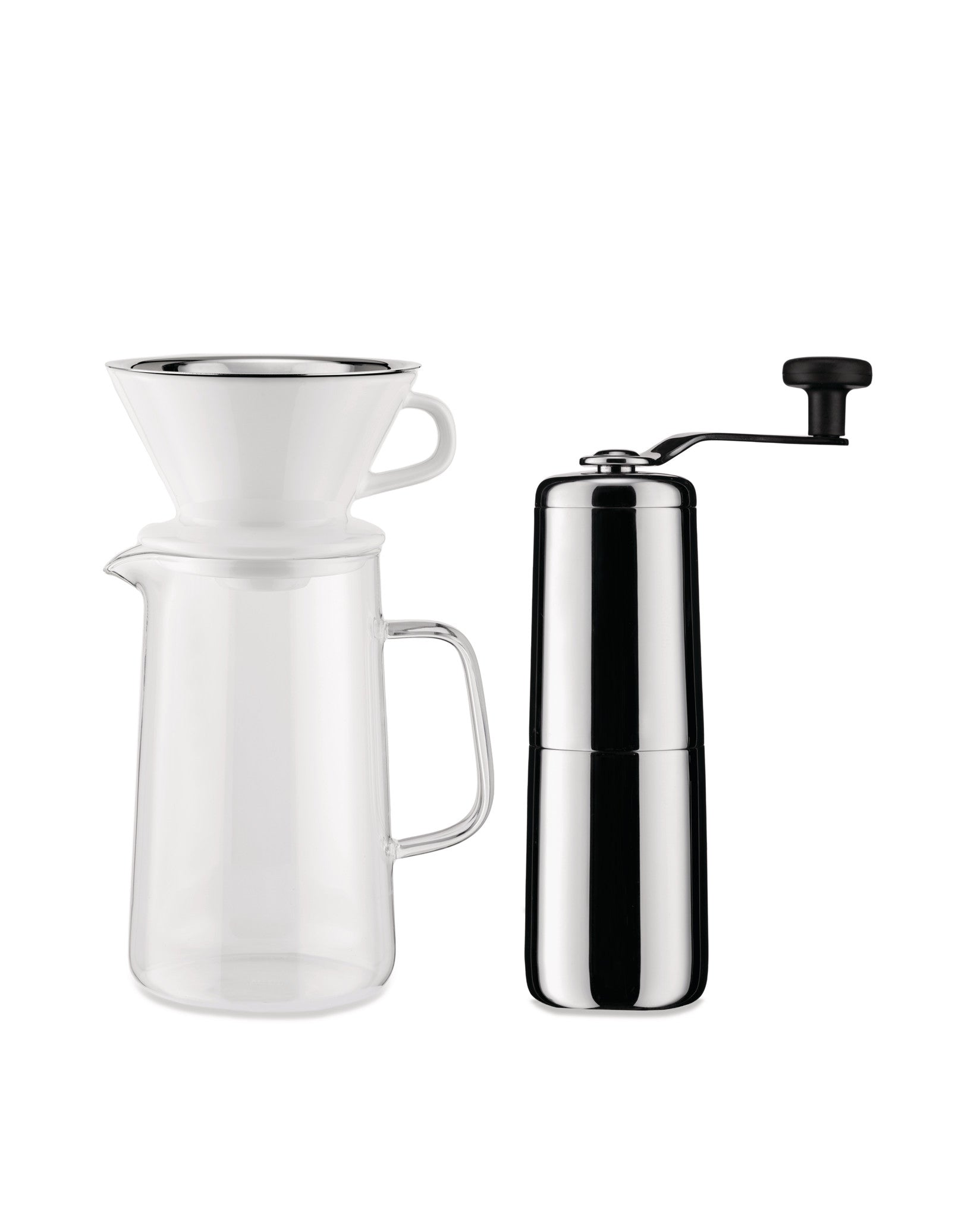 Polished chrome manual coffee grinder by Alessi, alongside a glass pour-over coffee carafe with white ceramic dripper.
