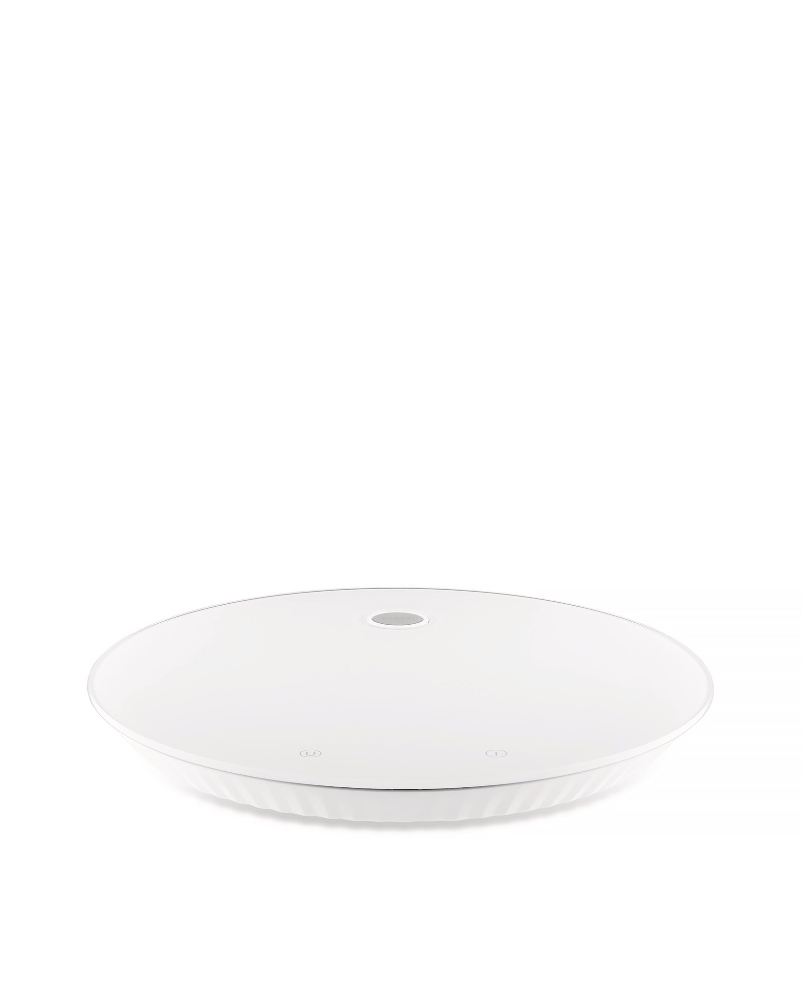 White round kitchen scale by Alessi with a ridged base and two subtle touch controls on the surface.