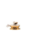 White and gold decorative swan container by Alessi with pearl accents and a ruffled edge.