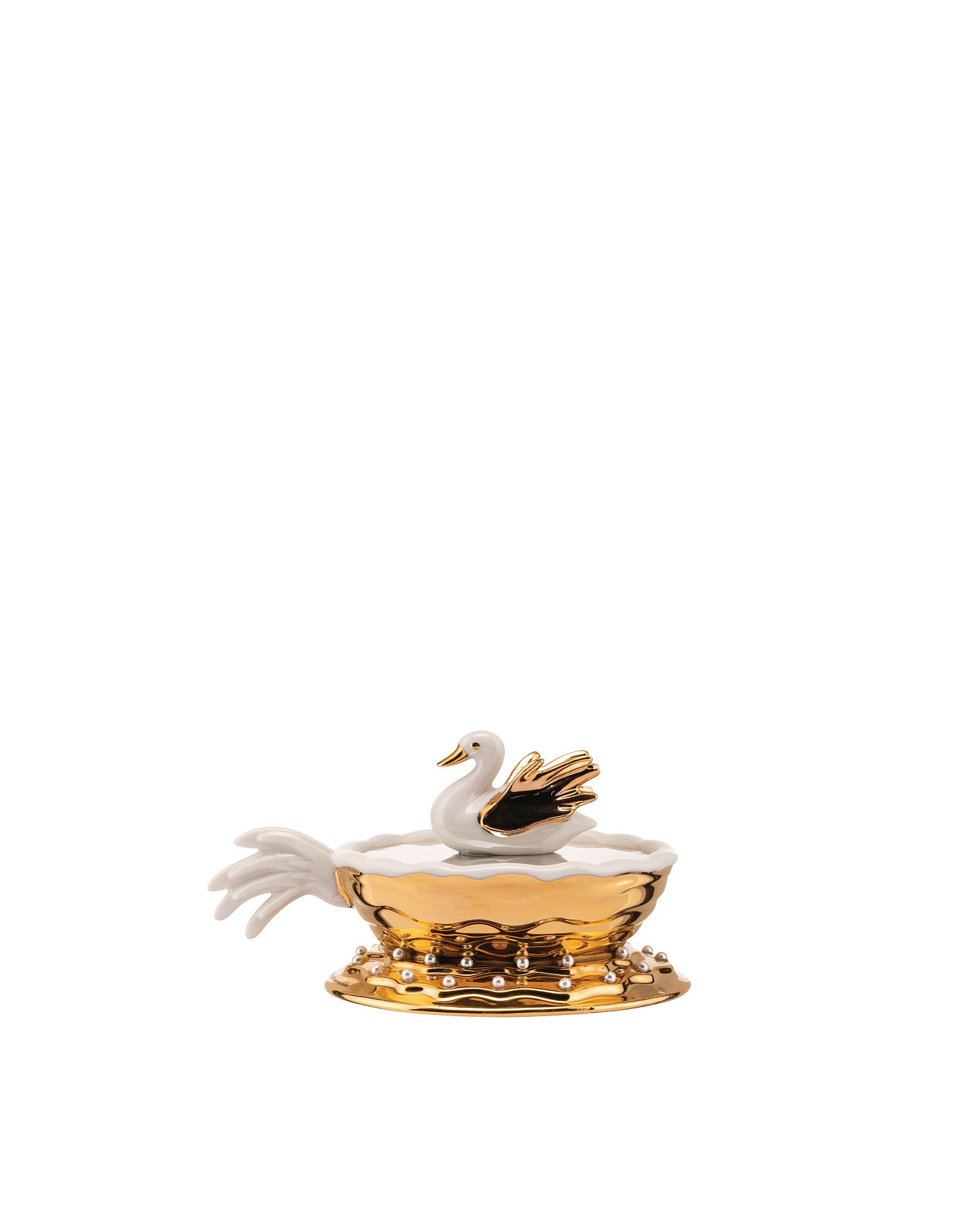 White and gold decorative swan container by Alessi with pearl accents and a ruffled edge.