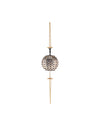 A spherical decorative ornament by Alessi, white and black checkerboard with clear rhinestones, held by black figures on a gold chain.