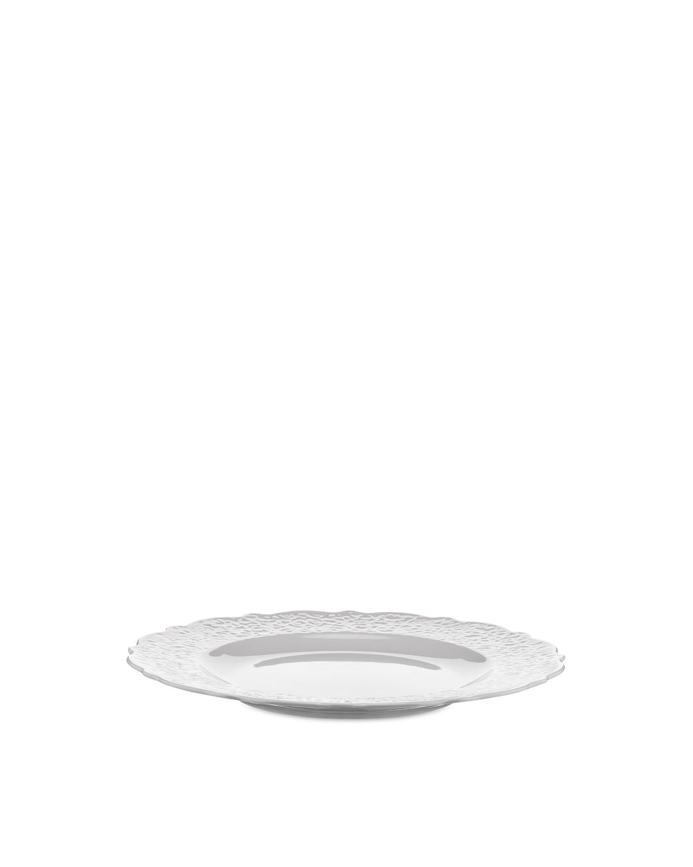White plate by Alessi featuring a decorative, textured wavy rim, presented at a low angle.