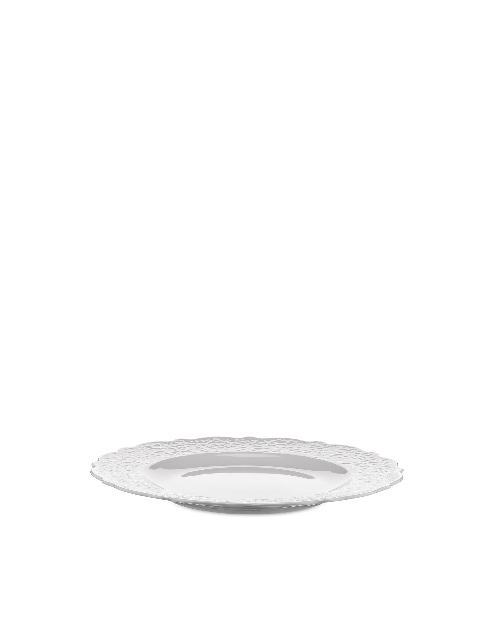 White plate by Alessi featuring a decorative, textured wavy rim, presented at a low angle.