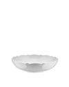 White shallow serving bowl by Alessi with a glossy finish and a wavy, scalloped rim.