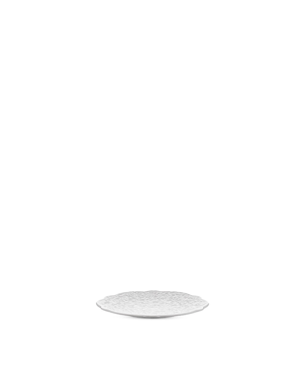 White textured plate by Alessi with a scalloped edge.