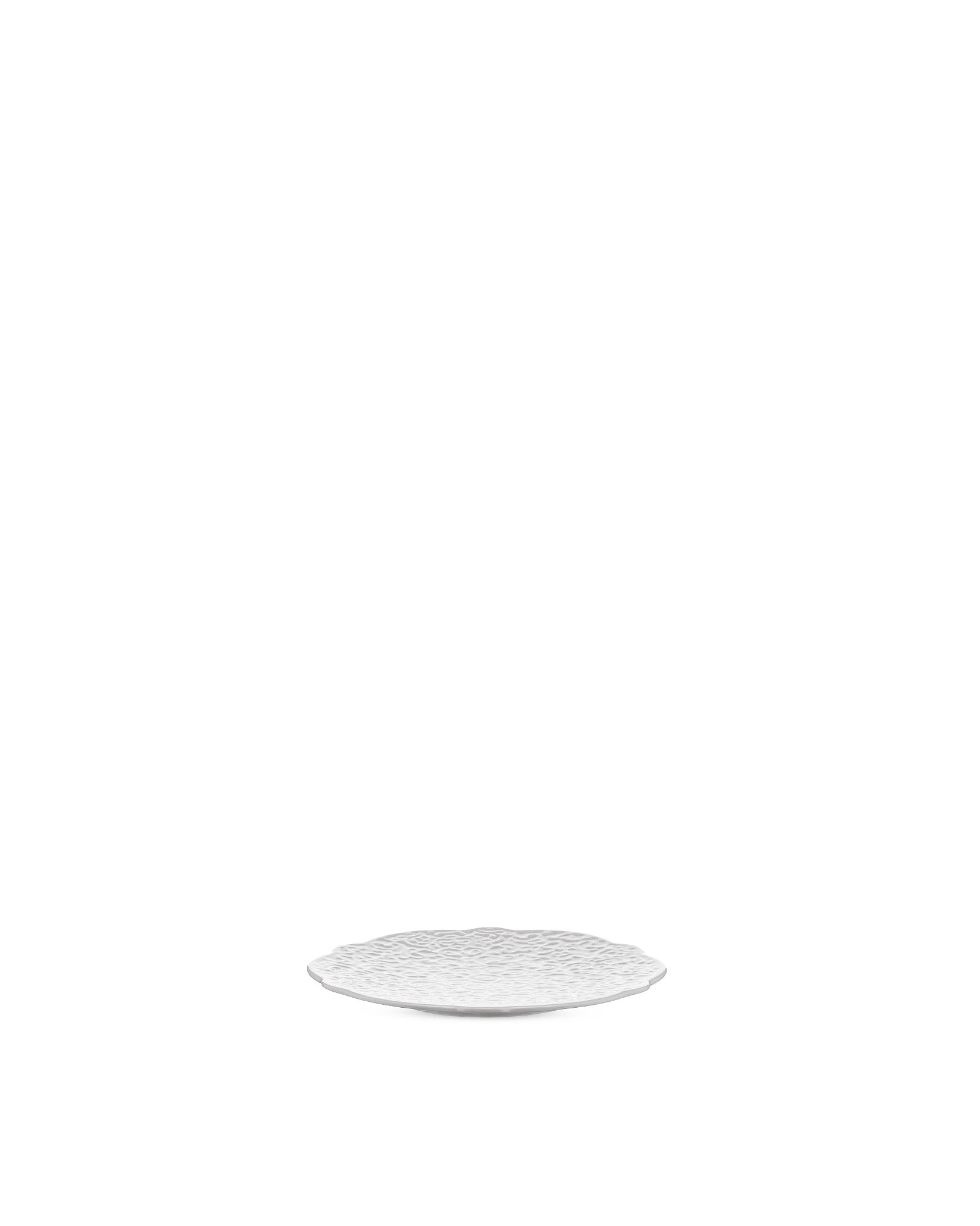 White textured plate by Alessi with a scalloped edge.