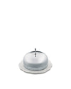 Silver covered butter dish by Alessi with a decorative knob and a white ceramic plate featuring an embossed scrollwork pattern.