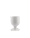 White glossy creamer by Alessi with a goblet-style base and small pouring spout.