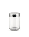 Clear glass storage jar by Alessi with a silver metal lid embossed with a swirling organic pattern.