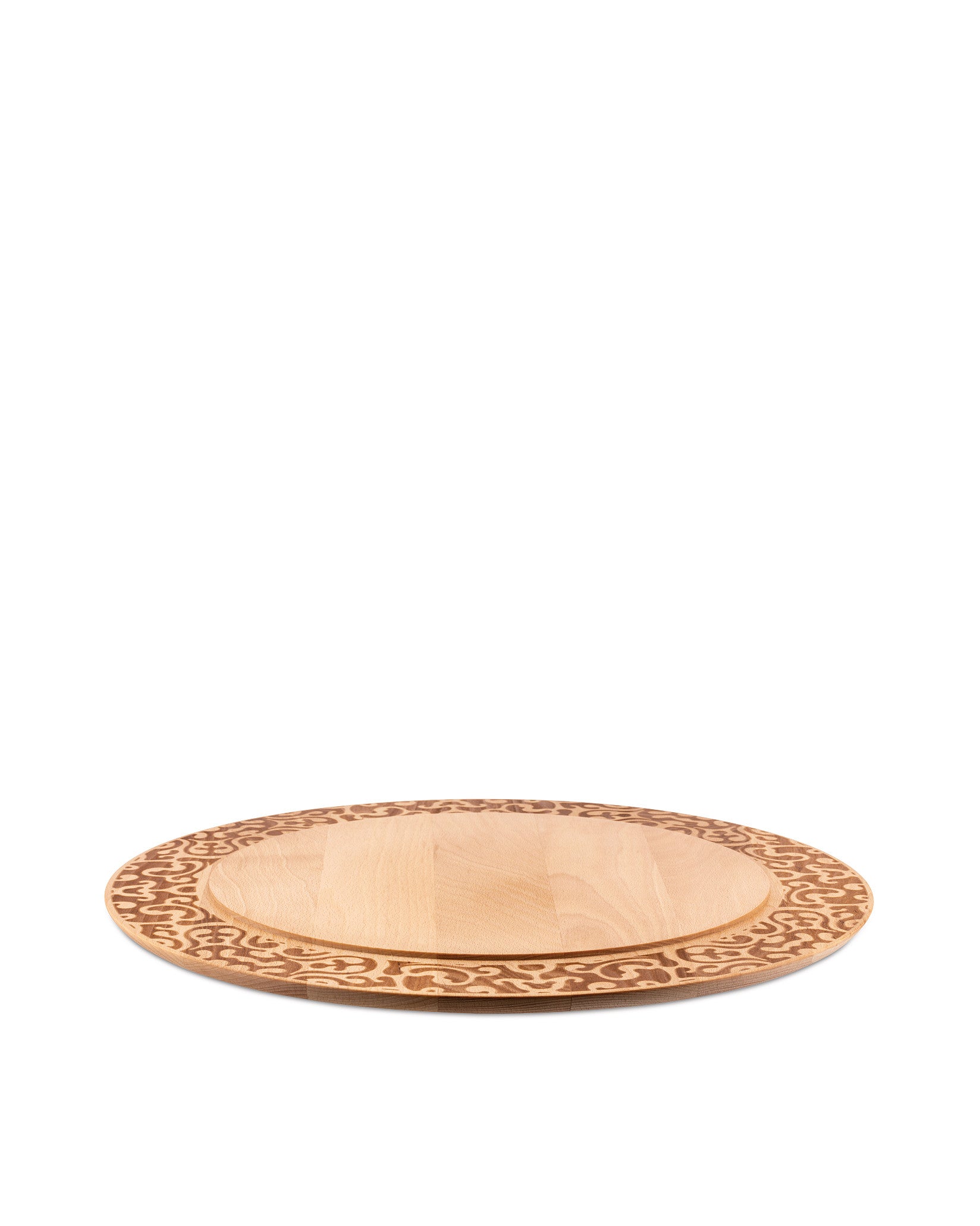 Light wood chopping board by Alessi with an ornate carved border, shown from a low angle.