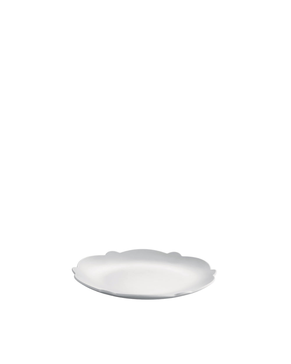 White scalloped plate by Alessi, shown at an angle.