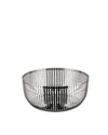 Polished silver metal bowl by Alessi with a vertical slatted design, on a white background.
