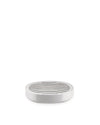 White oval soap dish by Alessi with a slatted draining top, shot from a slightly elevated front view.