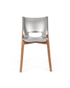 Silver metal and wood chair by Alessi with an oval cut-out back, front view.