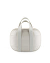 Multi-tiered light beige plastic lunchbox by Alessi, with an oval shape, two integrated handles, glossy top, and matte middle band with an embossed logo.