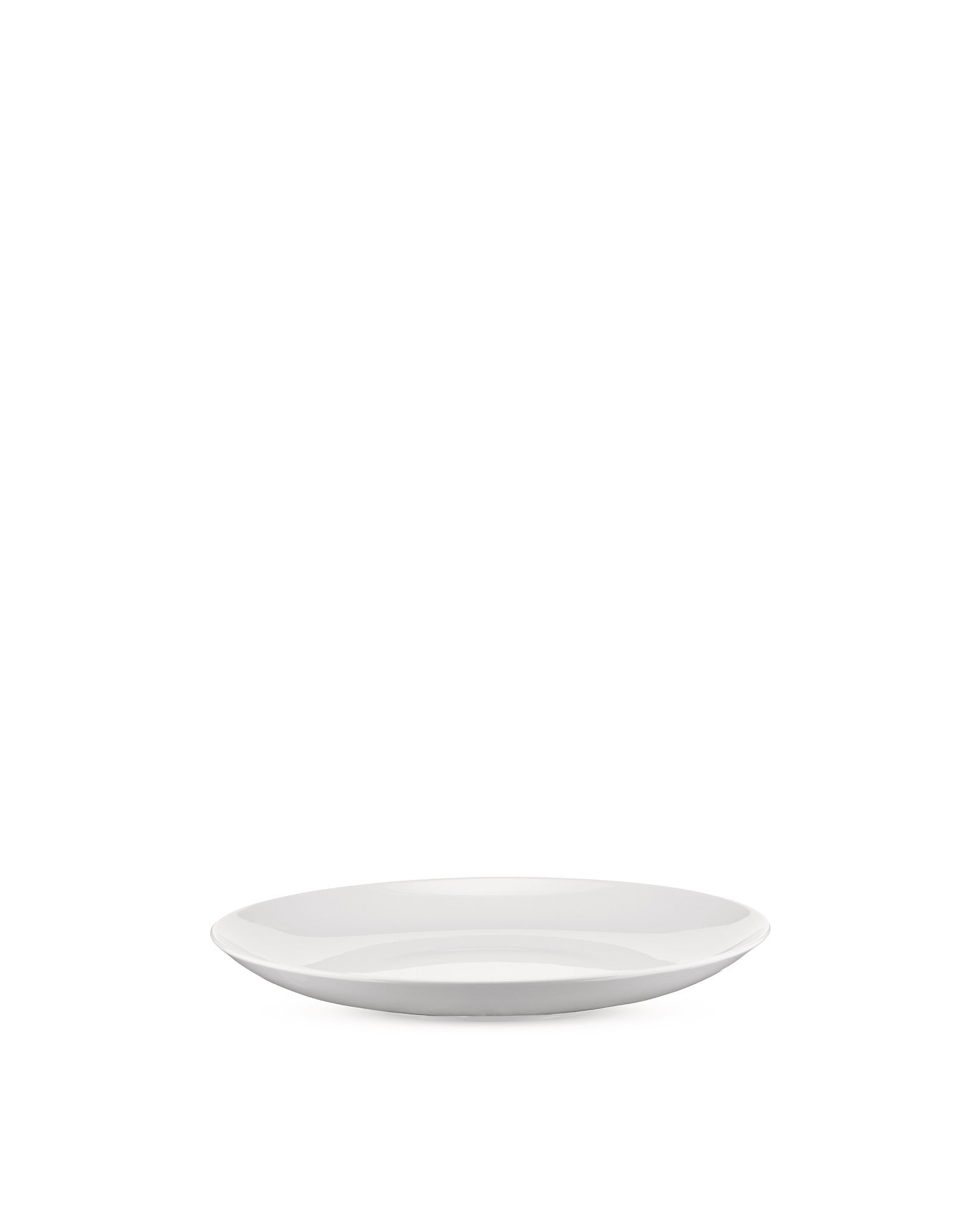 White, shallow oval plate by Alessi with a glossy finish, viewed from a low angle.