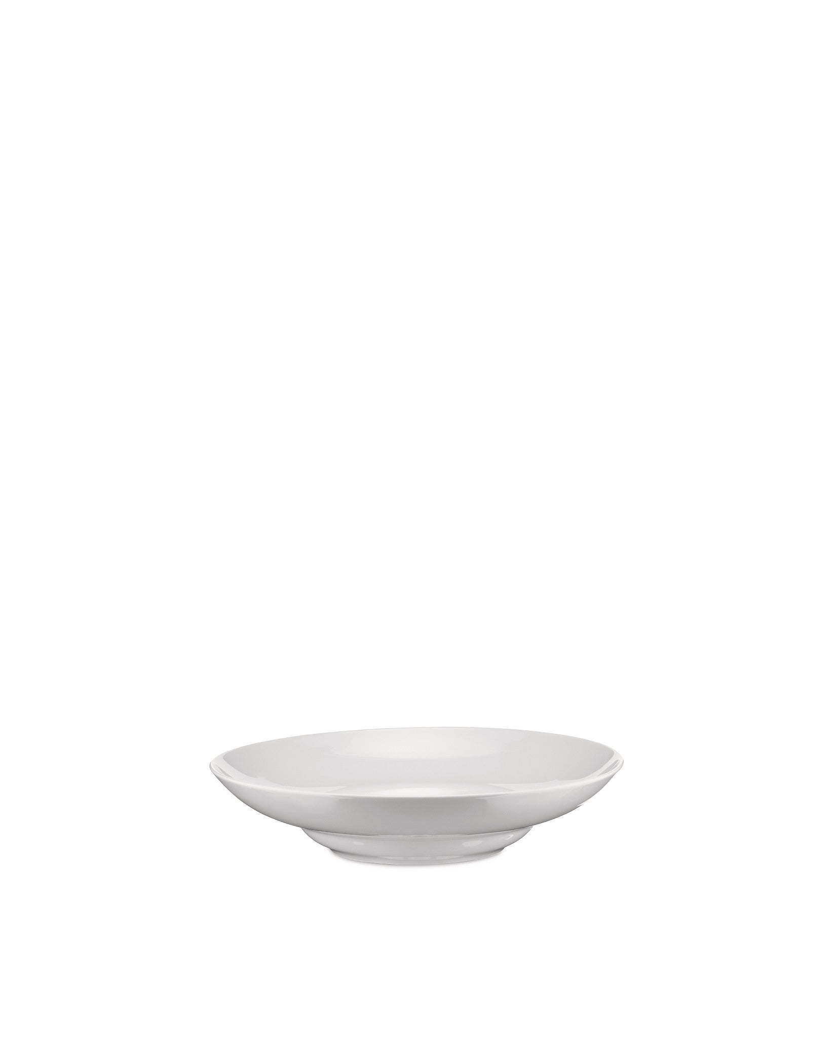 White bowl by Alessi, a simple, shallow serving bowl with a subtle elevated base, from a slightly elevated angle.