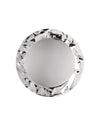 Round silver metal platter by Alessi with a hammered, wavy rim from a top view.