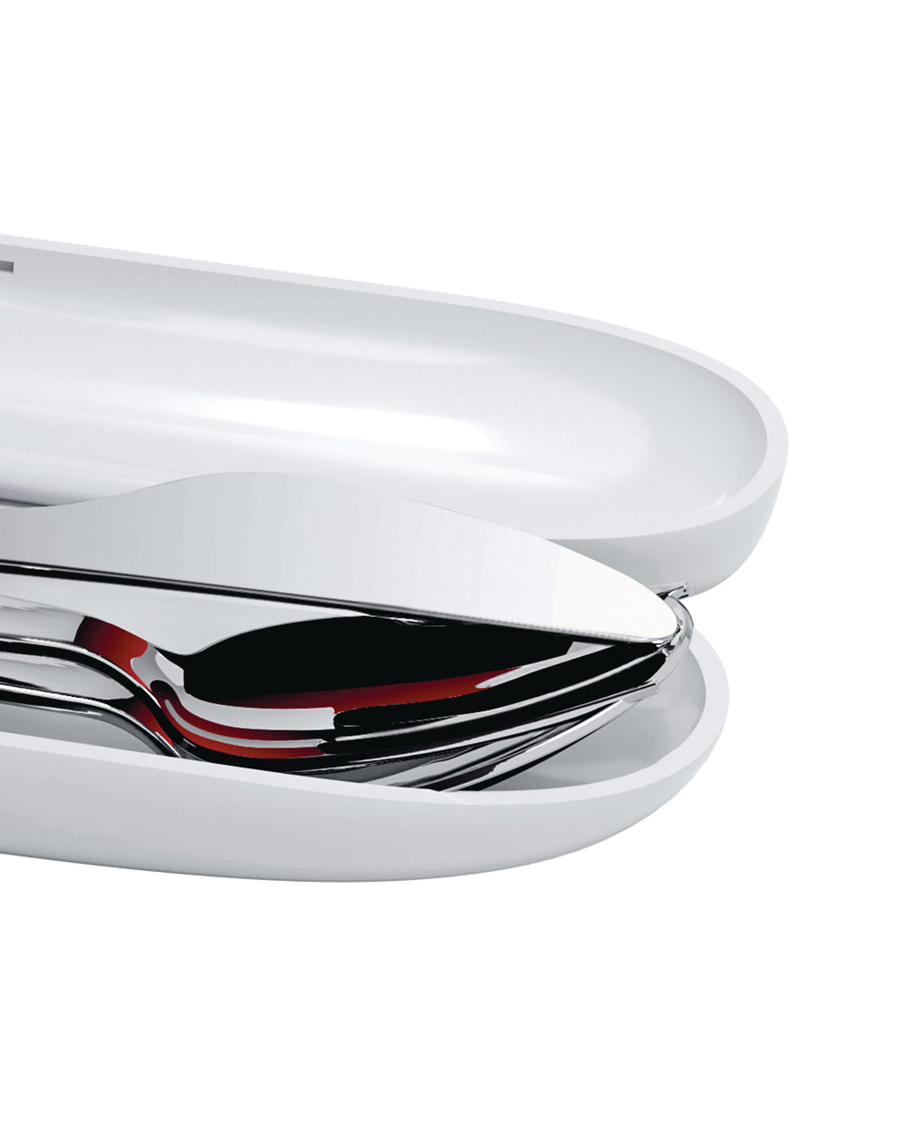 White portable food container by Alessi, partially open, revealing sleek chrome cutlery with red reflections.