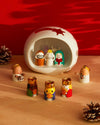 Colorful ceramic Re Magi figures by Alessi, holding gifts with gold crowns in a modern nativity scene.
