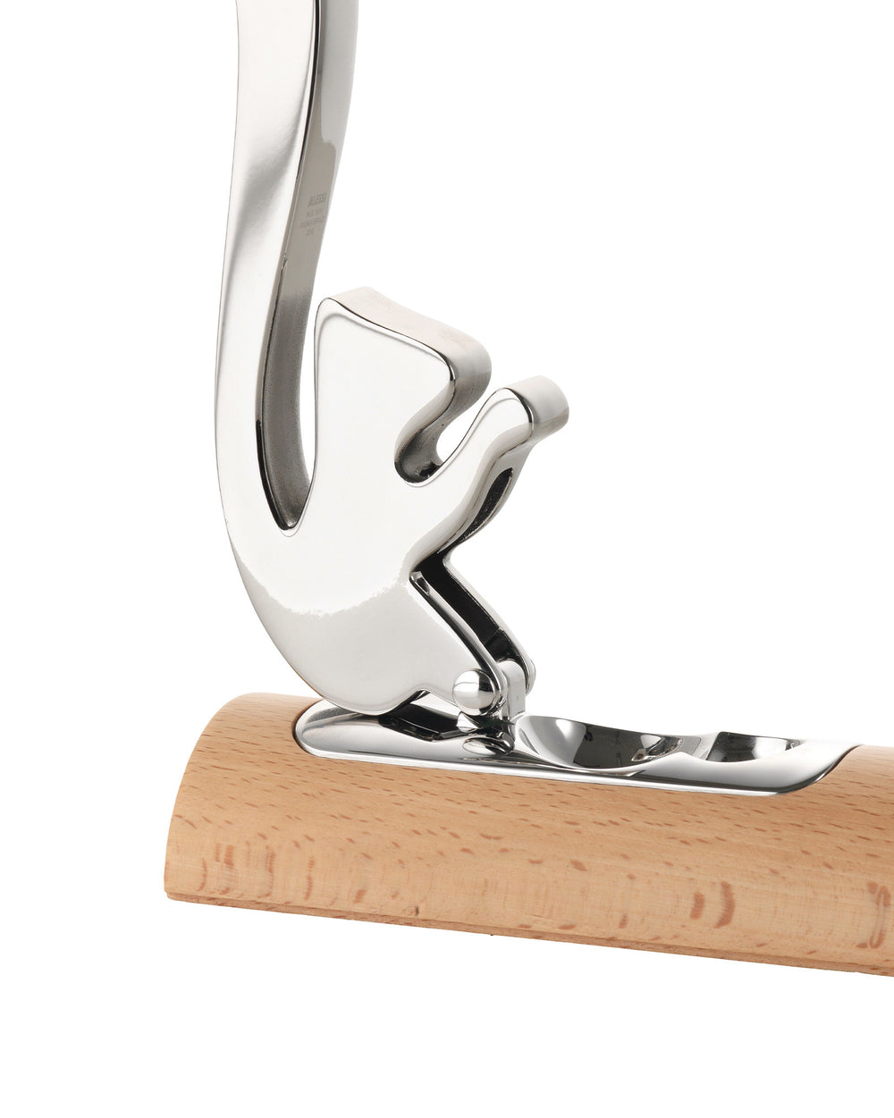 Polished chrome-plated metal nutcracker by Alessi with a squirrel-shaped top hinged to a light wooden base.