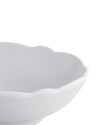 White scalloped bowl by Alessi with a close-up, cropped view.