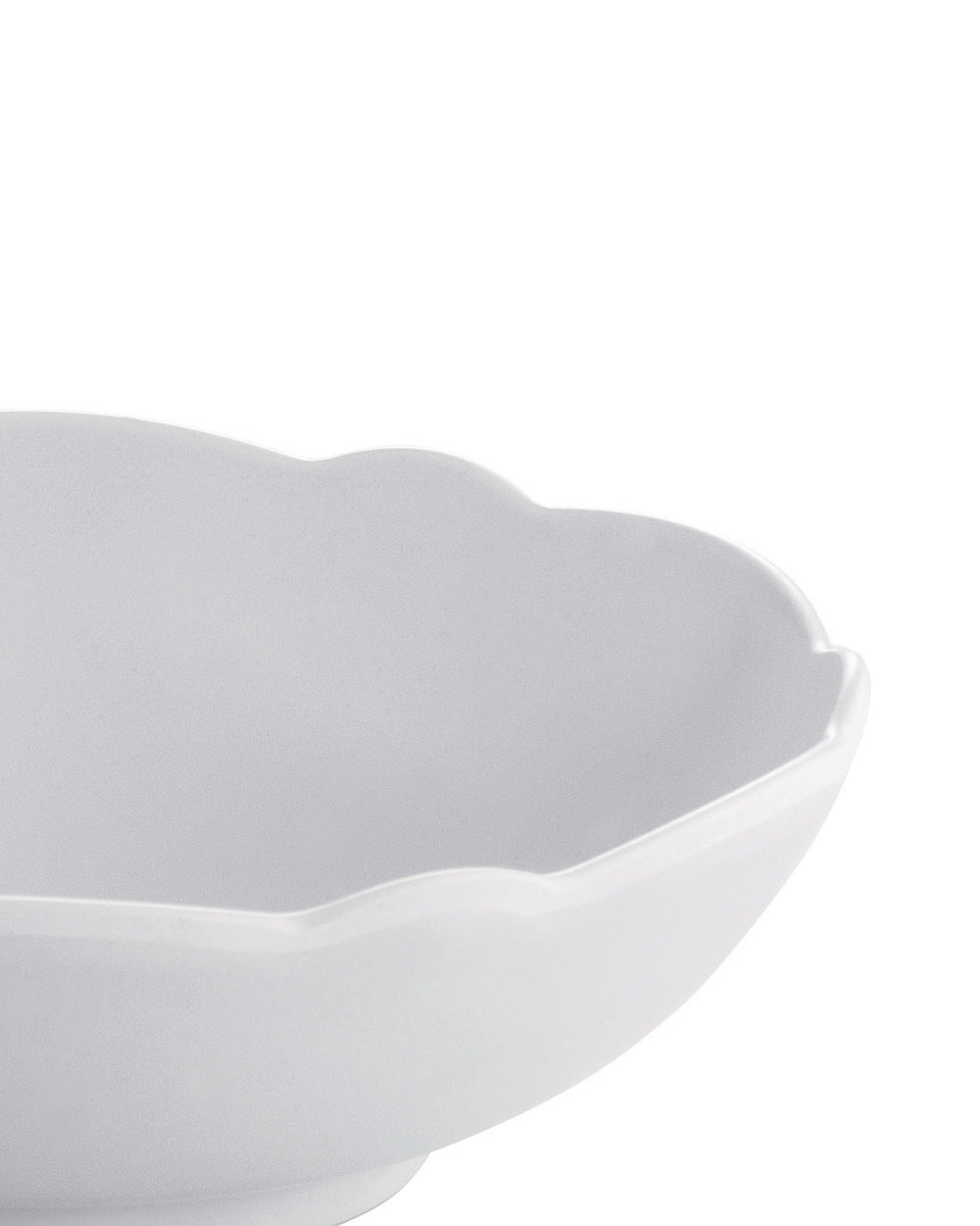 White scalloped bowl by Alessi with a close-up, cropped view.