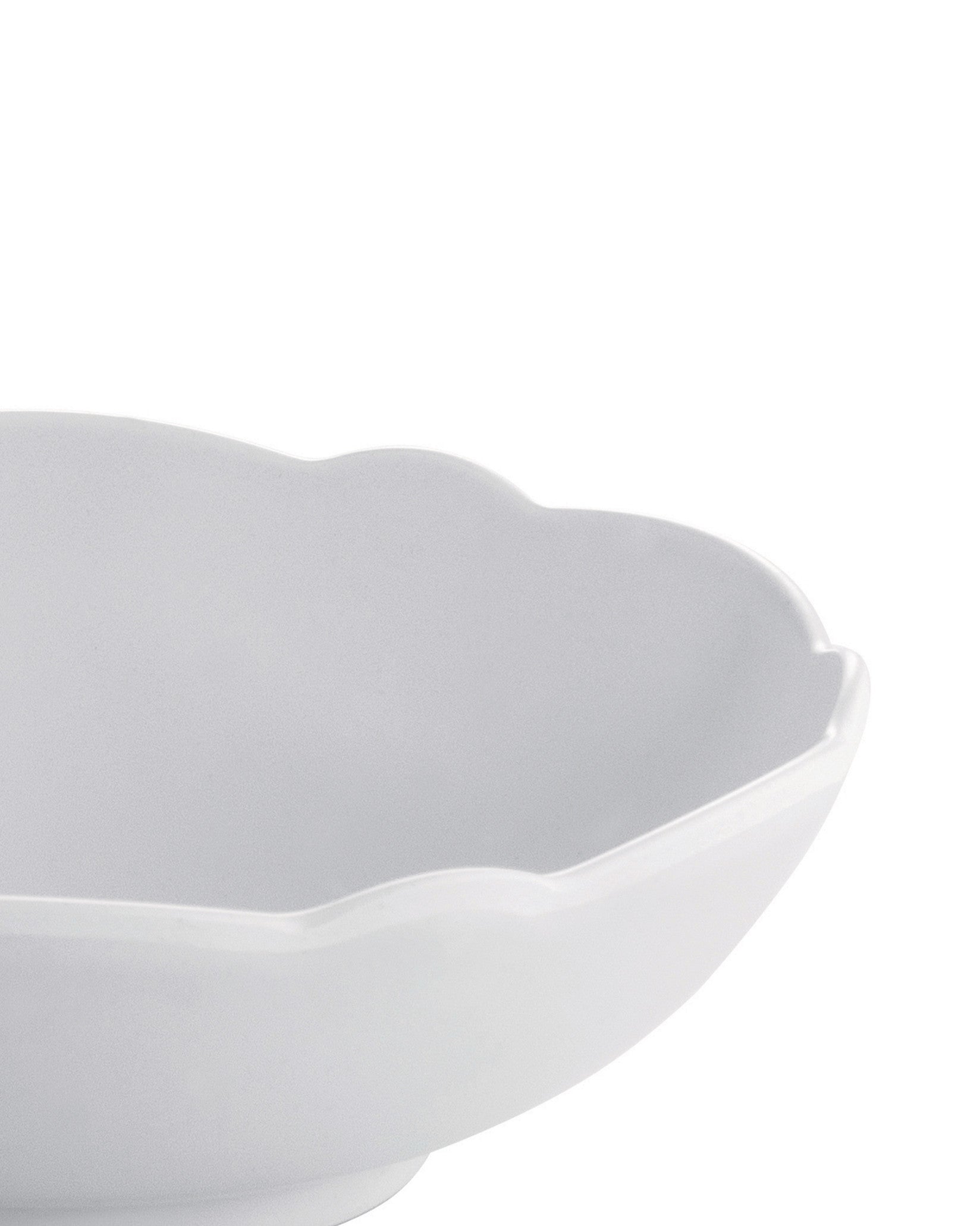 White scalloped bowl by Alessi with a close-up, cropped view.