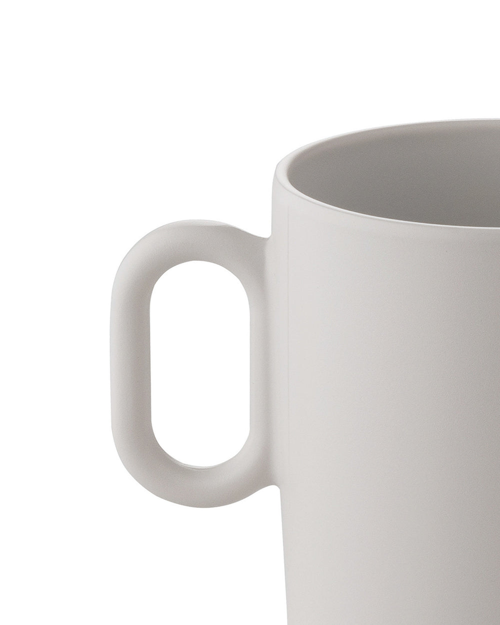 Light grey ceramic mug by Alessi with a smooth matte finish and minimalist handle, cropped.