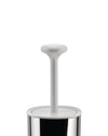 White and chrome toilet brush and holder by Alessi, with a white rounded handle and polished cylindrical base.
