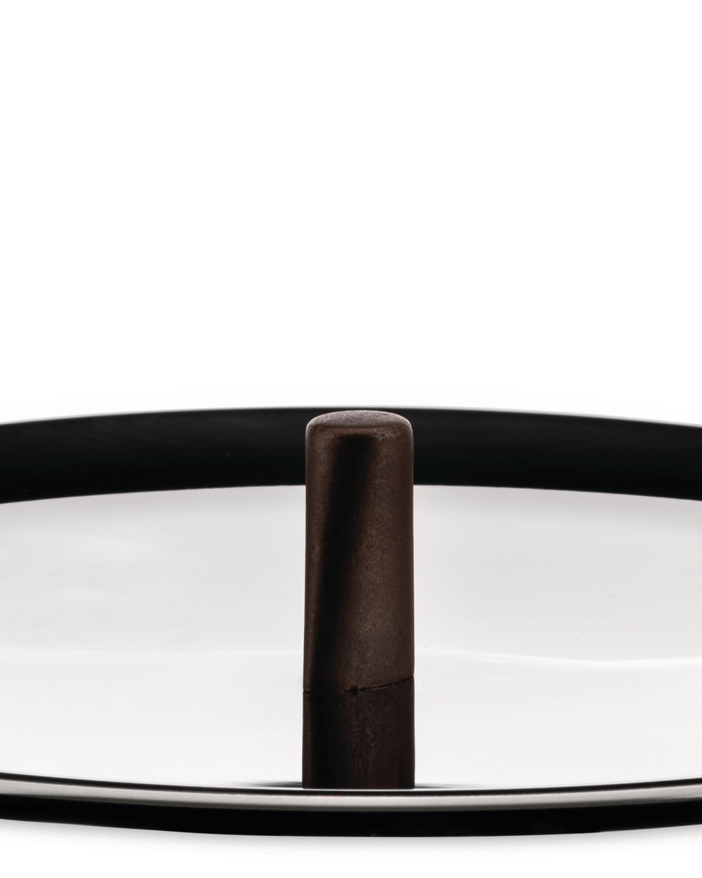 Dark brown textured cylindrical cookware knob by Alessi, standing on a reflective silver surface with a black rim.