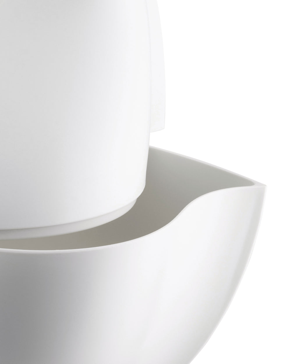 White, smooth, minimalist pitcher by Alessi, featuring a curved spout and stacked components.