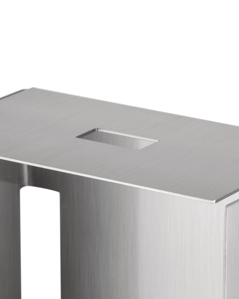 Brushed stainless steel container by Alessi, with a rectangular top slot and a side cutout.