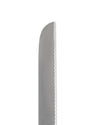 Silver metal knife blade by Alessi with a serrated edge and rounded tip, close-up.
