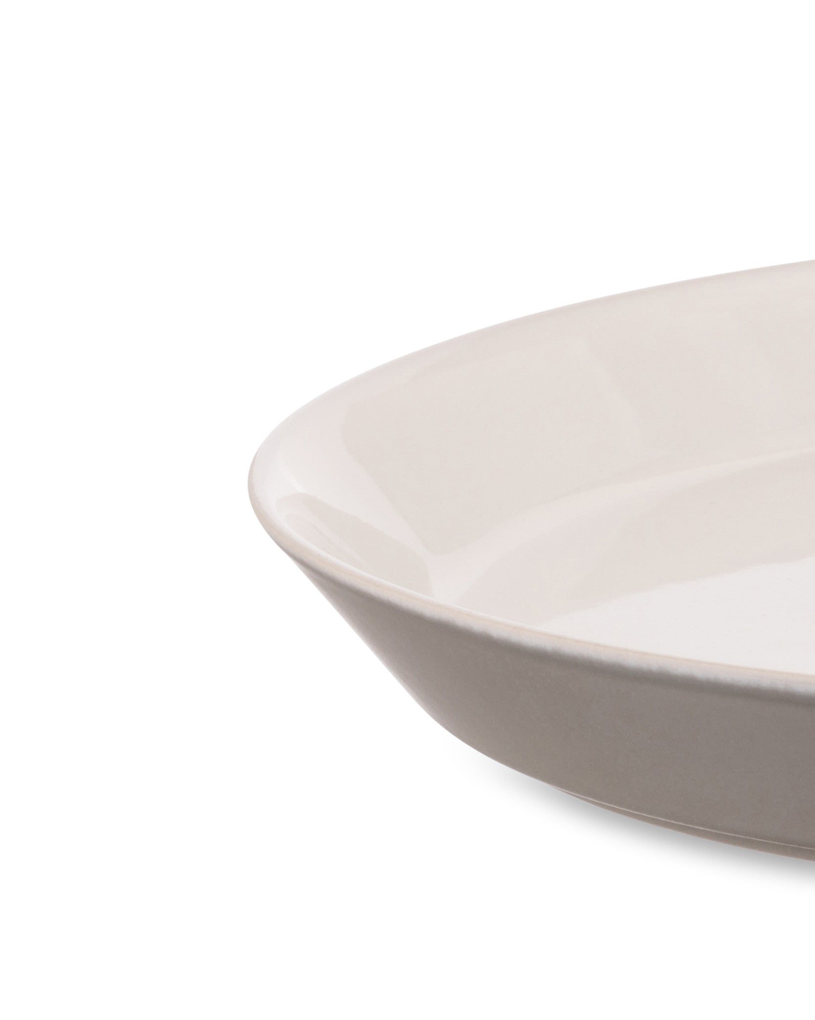 Cream white oval serving dish by Alessi with a glossy interior and a textured beige outer rim.