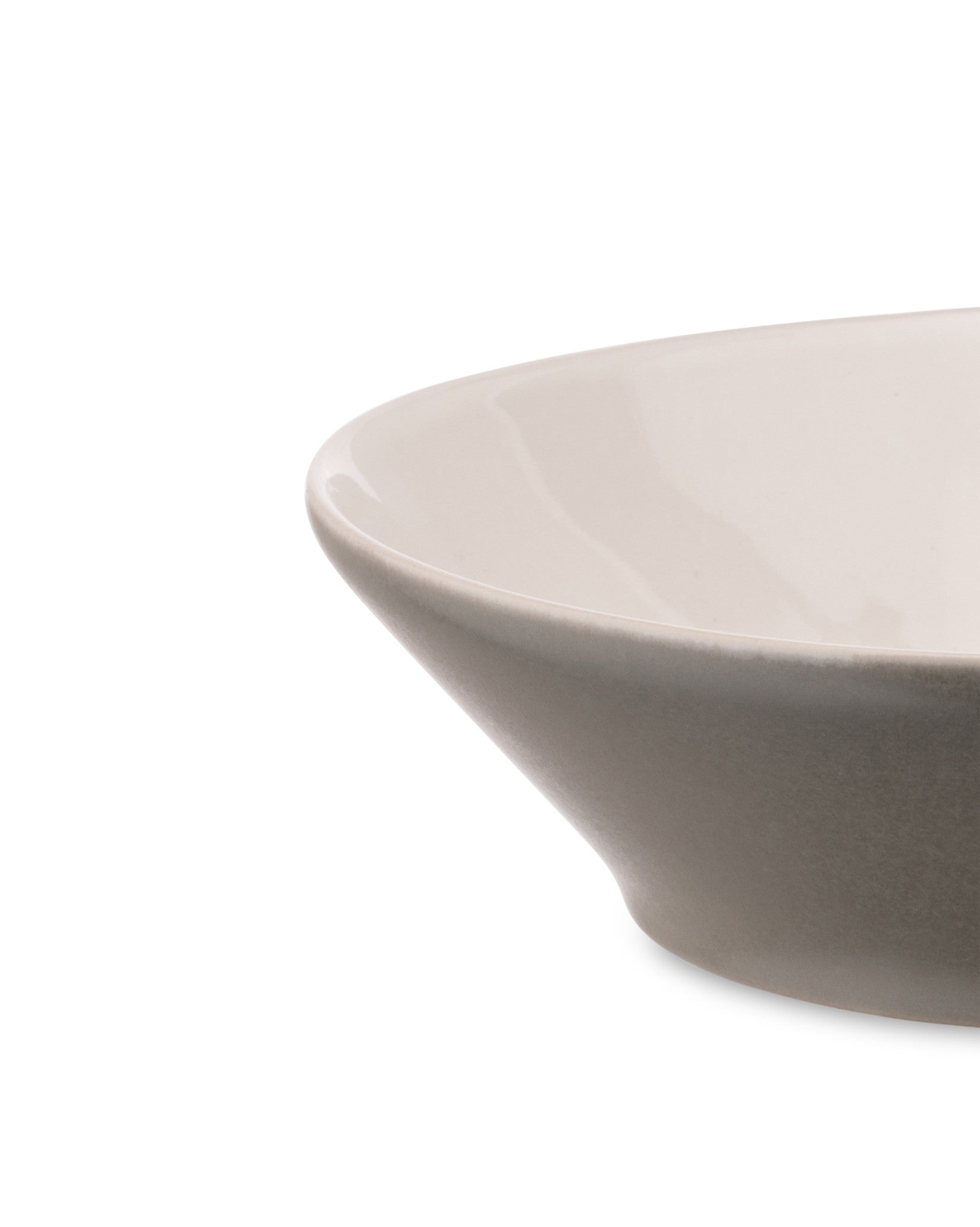 Two-toned ceramic bowl by Alessi with a cream interior and gray exterior, shown in a close-up.