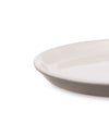 Light beige plate by Alessi, with a subtle taupe rim and glossy interior, shown cropped.
