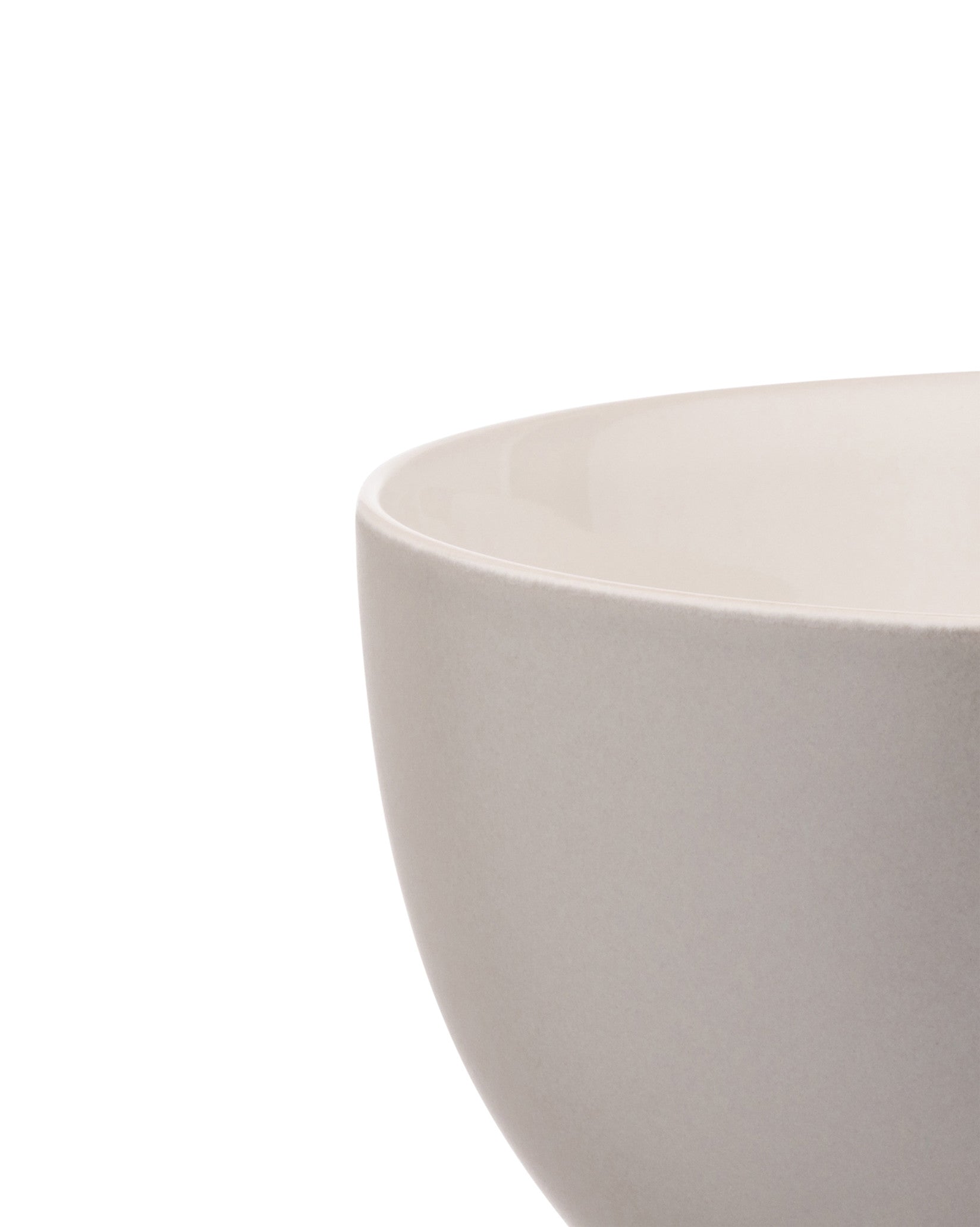 Light grey ceramic bowl by Alessi with a matte exterior and glossy inner rim, cropped side view.