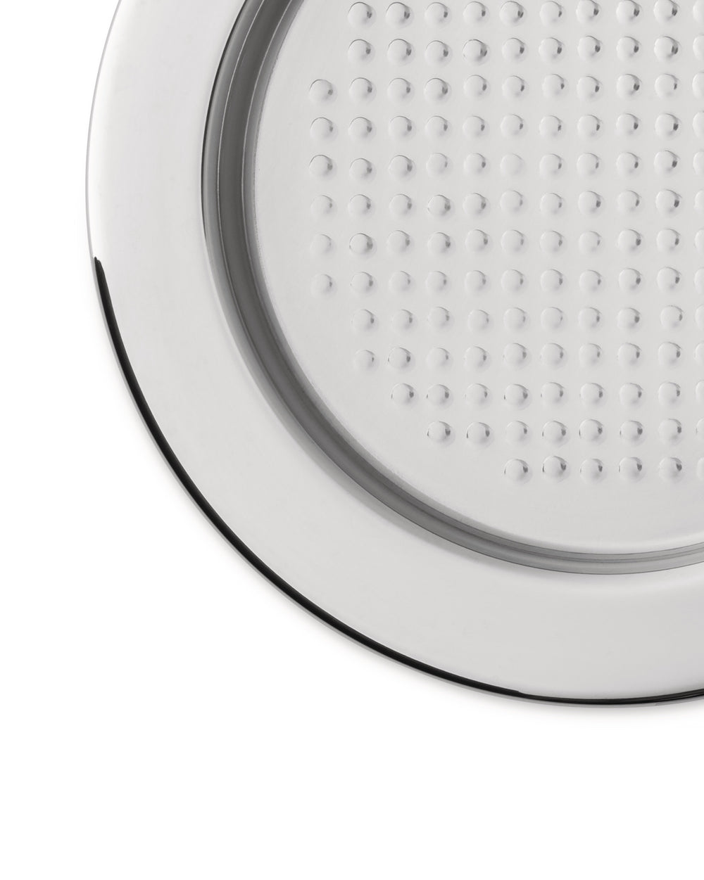 Cropped round silver metal plate by Alessi, with a grid of raised dots and a smooth rim.