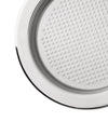 Polished chrome round metal insert by Alessi, featuring a surface with small circular dimples, in a cropped view.
