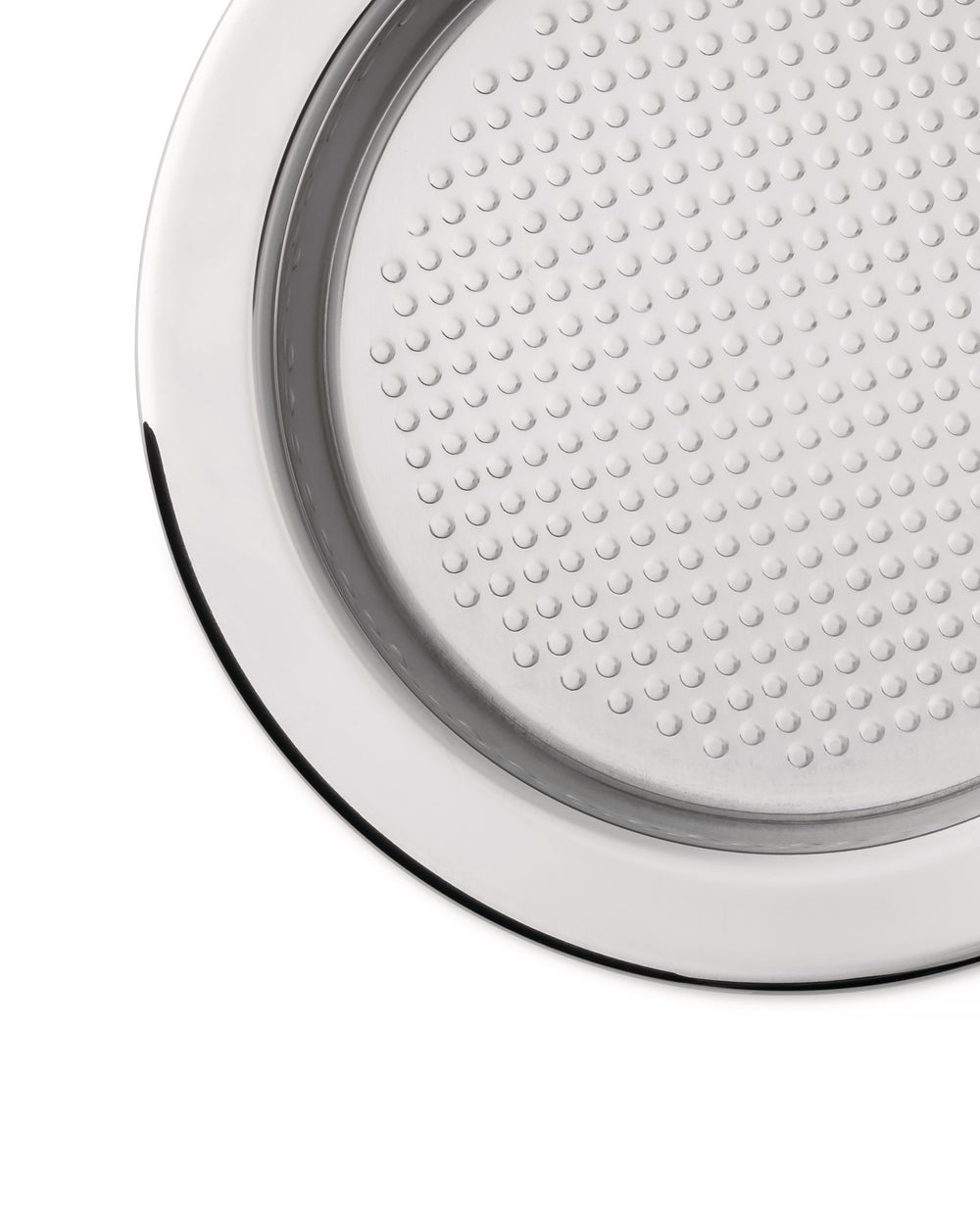Polished chrome round metal insert by Alessi, featuring a surface with small circular dimples, in a cropped view.